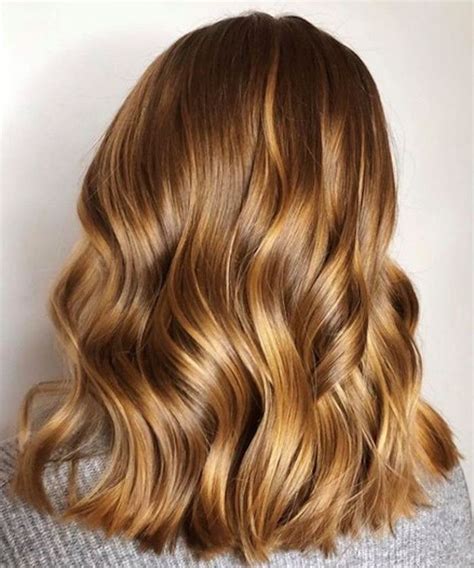 the honey blonde hair color trend is so pretty you d want to book in