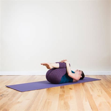 knees  chest yoga poses     bed popsugar fitness photo