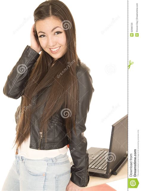 cute asian american teen girl by her computer posing stock