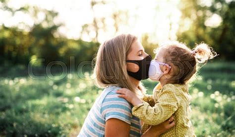 side view of happy mother kissing small stock image colourbox