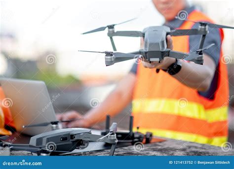 asian man engineer  drone  laptop  construction site stock photo image  aerial