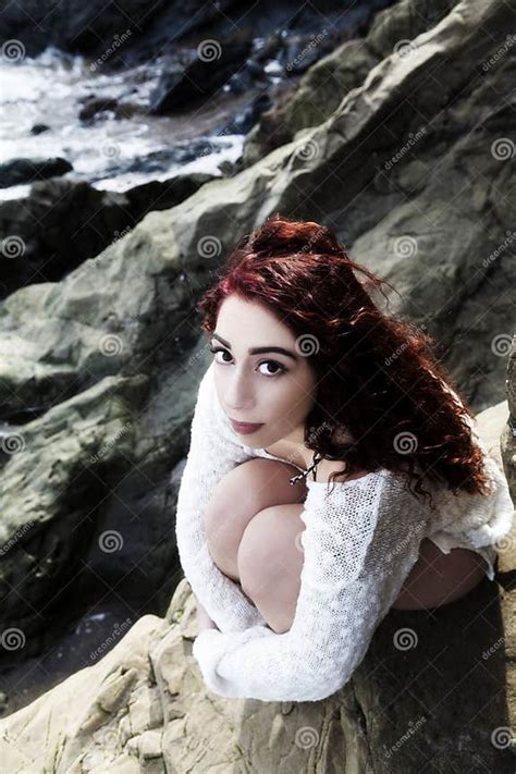 latina woman sitting on rocks in bikini from above stock image image