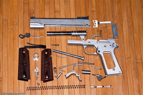 disassembled kimber  pistol   components   ki flickr
