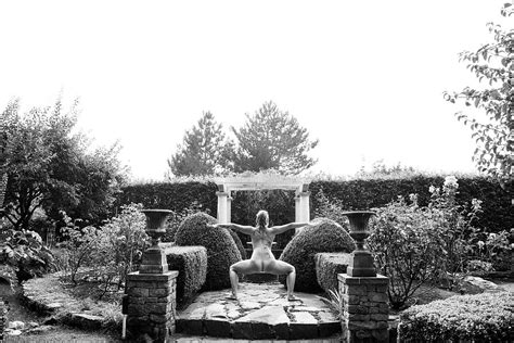 woman posing naked in formal garden photograph by panoramic images