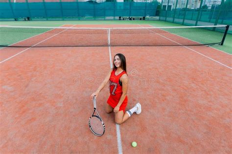 Beautiful Female Tennis Player On Tennis Court Red Dress Stock Image