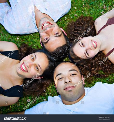 young people laying    grass smiling stock photo