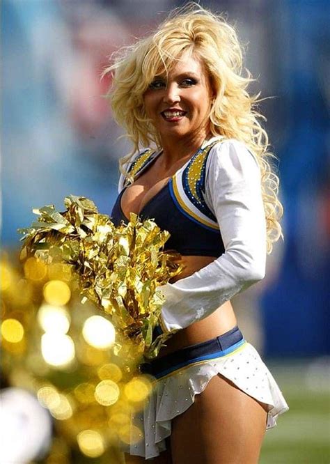 A Cheerleader Is Posing For The Camera