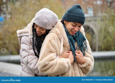 Dominican Lesbian Couple Hugging With Affection And Love At Street In