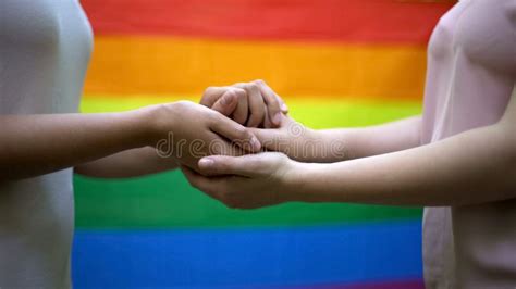 lesbians holding hands rainbow flag on background lgbt rights and