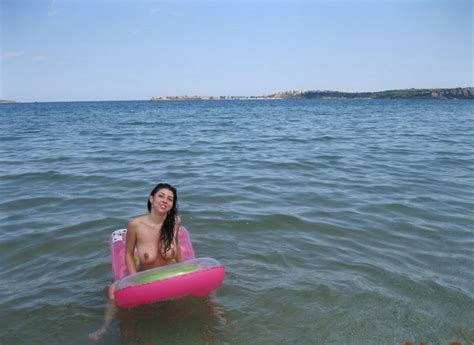 smiling brunette with very big boobs posing topless at public beach russian sexy girls