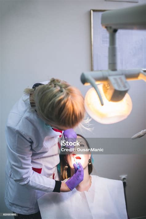 beautiful woman patient having dental treatment at dentists office