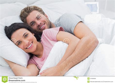 couple embracing in bed royalty free stock image image