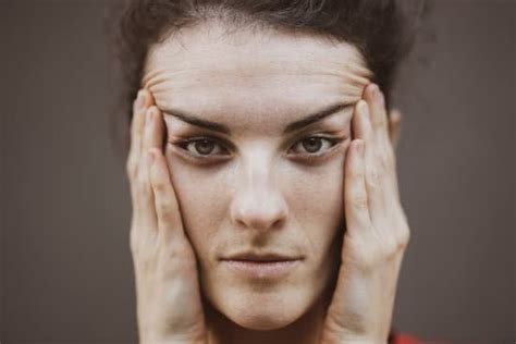 woman touching her face photos by canva