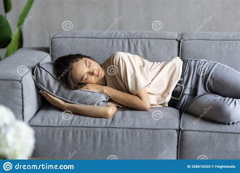 Young Attractive Woman Sleeping On The Couch In The Living Room Stock