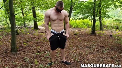 Muscular Dude Strokes His Cock Outdoors While Wearing A De