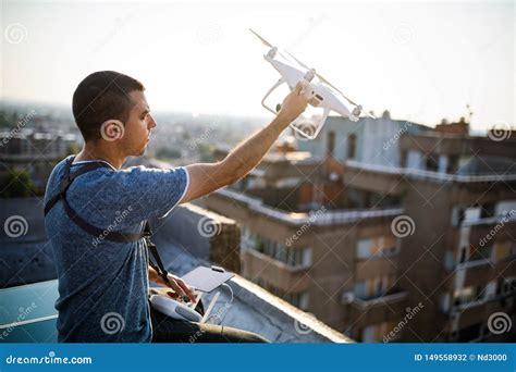 young technician flying uav drone  remote control  rooftop stock photo image  control