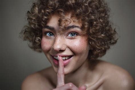 Smiling Beautiful Young Freckled Girl With Keep Quiet Gesture