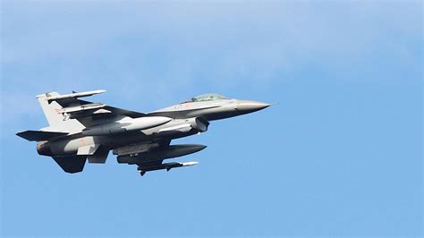 grey fighter jet flying  stock photo