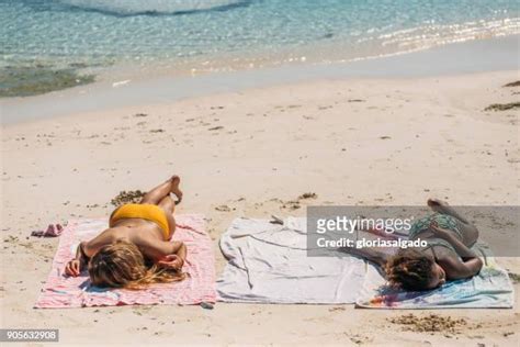 Girls Sunbathing On The Beach Photos And Premium High Res Pictures