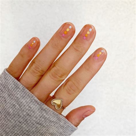 this rainbow dot nail art tutorial is perfect for pride month — and