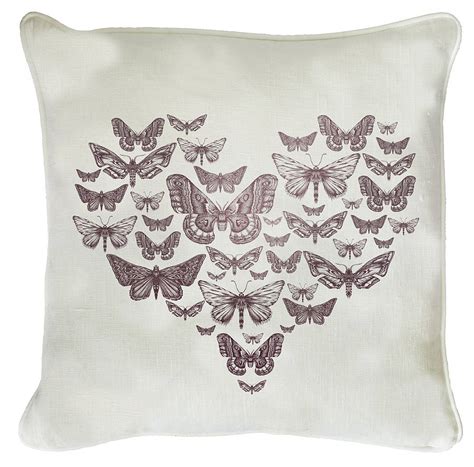 pink butterfly heart cushion on white linen by natural history the
