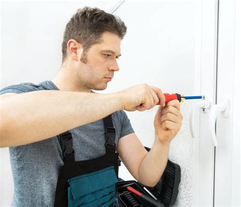 professional handyman fixing window stock photo image  fixing bolt