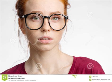 Redhead Woman In Glasses With Hair Knot Looking At Camera