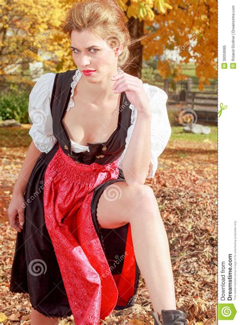 beautiful woman in a dirndl in an autumn park royalty free