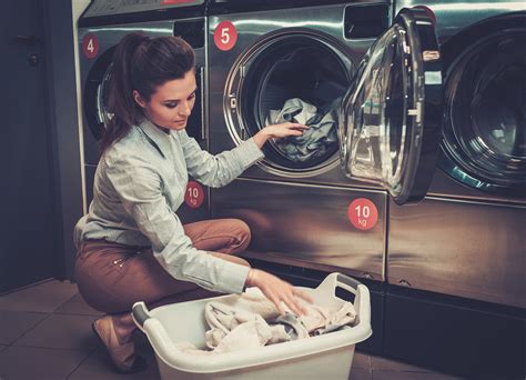 beautiful woman doing laundry at laundromat shop t and l equipment
