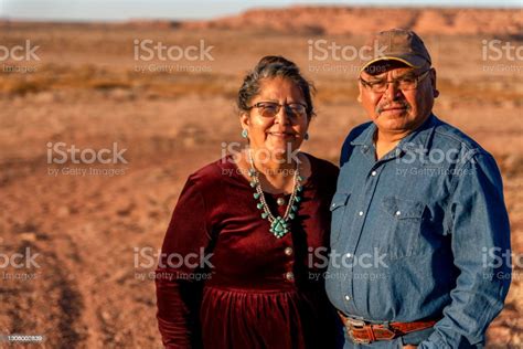 A Happy Smiling Native American Husband And Wife Near Their Home In
