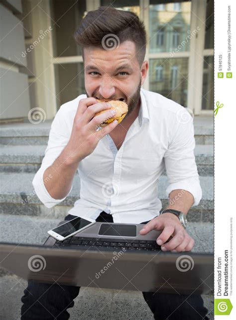 cheeseburger on laptop keyboard a fast food lunch in the