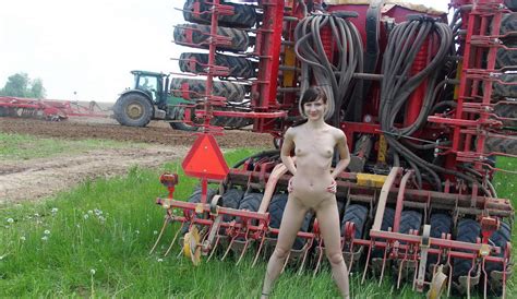 russian girl undressing in front of a tractor on the field russian sexy girls