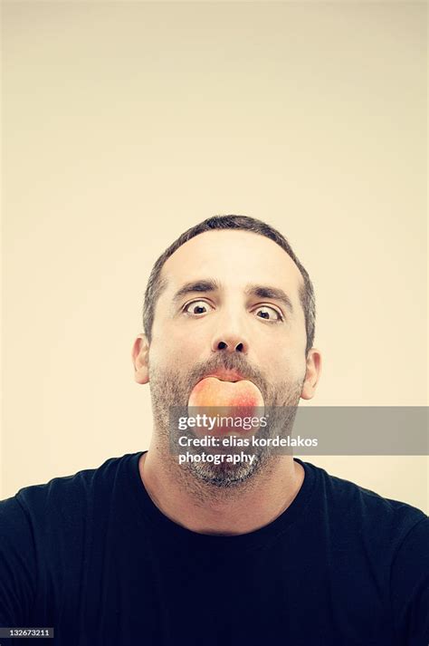 man holding apple   mouth high res stock photo getty images