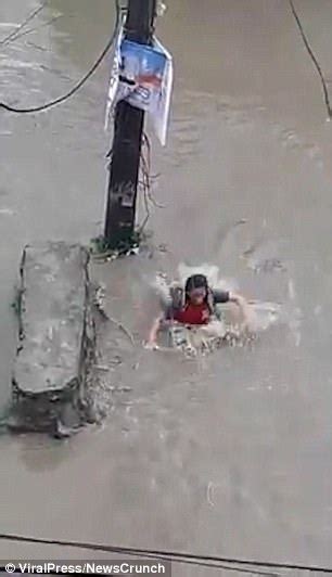 horrifying moment girl falls into an open drain in nepal