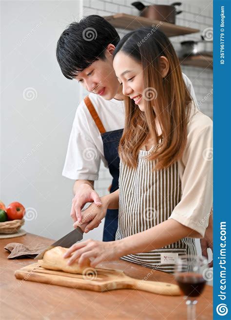 Happy Asian Couple Making Brunch In The Kitchen Together Preparing