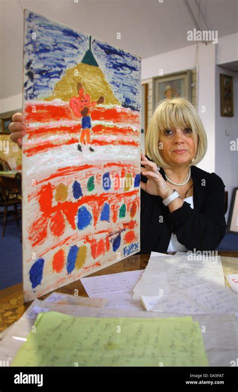 Carol Ann Kelly Poses With A Picture And Letters Painted And Written