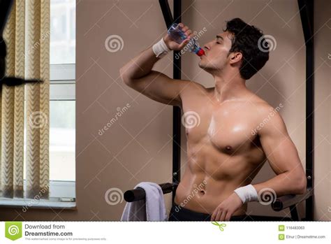 The Thirsty Man Drinking Water In Sports Gym Stock Image
