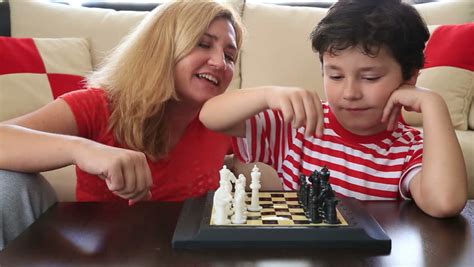 mother teaches son how to play chess stock footage video 6478703 shutterstock