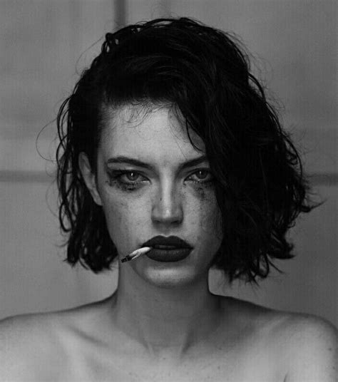 black and white photograph of a woman with freckles on her face holding