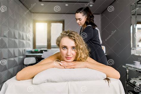 Front View Of Young Female Client Enjoying Relaxing Full Body Massage