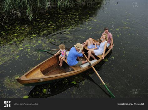 family  rowing boat  lake stock photo offset