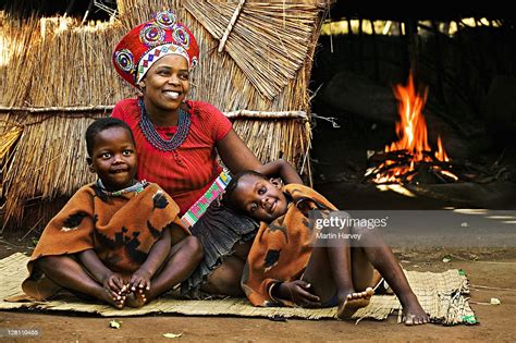 zulu woman in traditional red headdress of a married woman with her