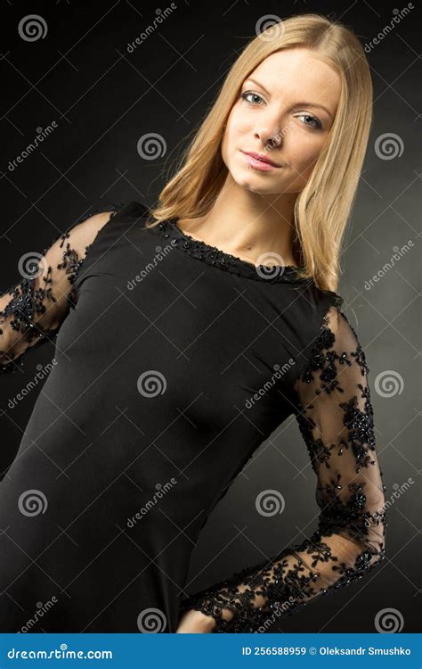 Young Beautiful Woman Wearing Black Evening Dress With Naked Shoulders