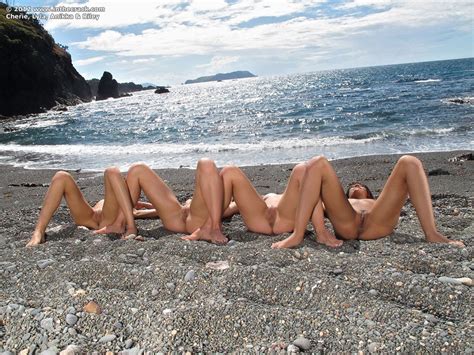 hot slut lyla storm and friends shed bikinis to pose naked on beach on knees