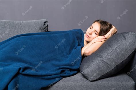 Free Photo Young Girl Sleeping On A Sofa Covered With Blue Coverlet
