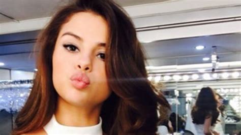 selena gomez puckers up in a white halter dress selfie rocks two toned