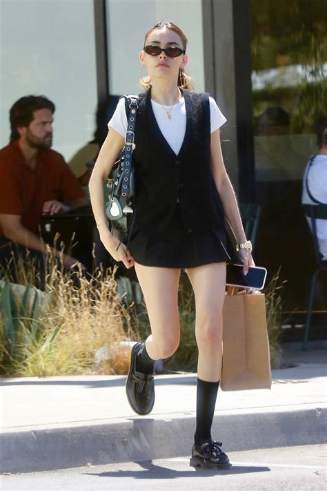 madison beer puts on a leggy display in a black mini skirt while out on