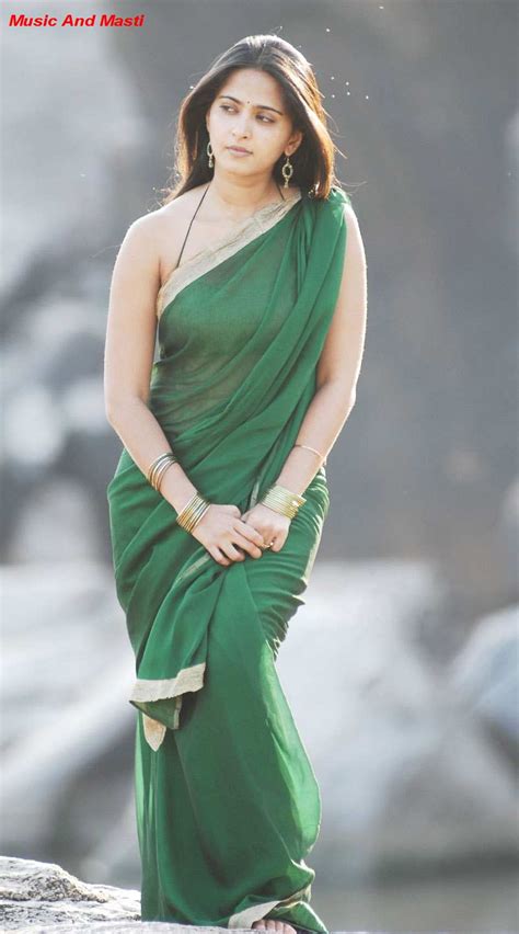 music and masti anushka in green saree strip sleeveless top