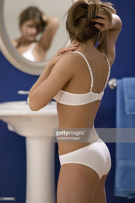 Woman In Lingerie In Front Of Bathroom Mirror High Res