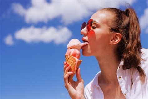 Premium Photo Girl Licks Ice Cream In A Cone Closeup In Hot Summer